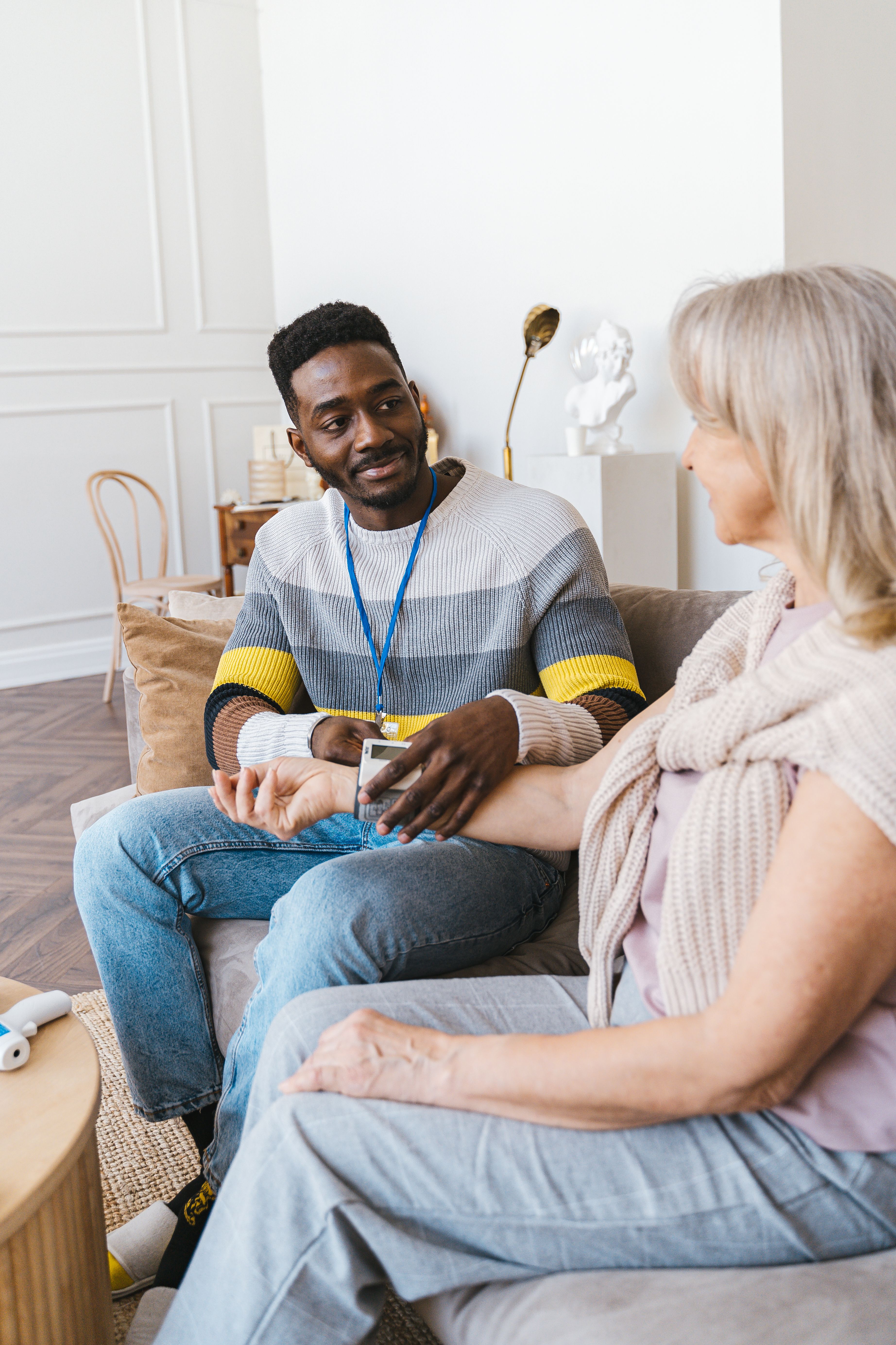 Carer sitting with elderly woman