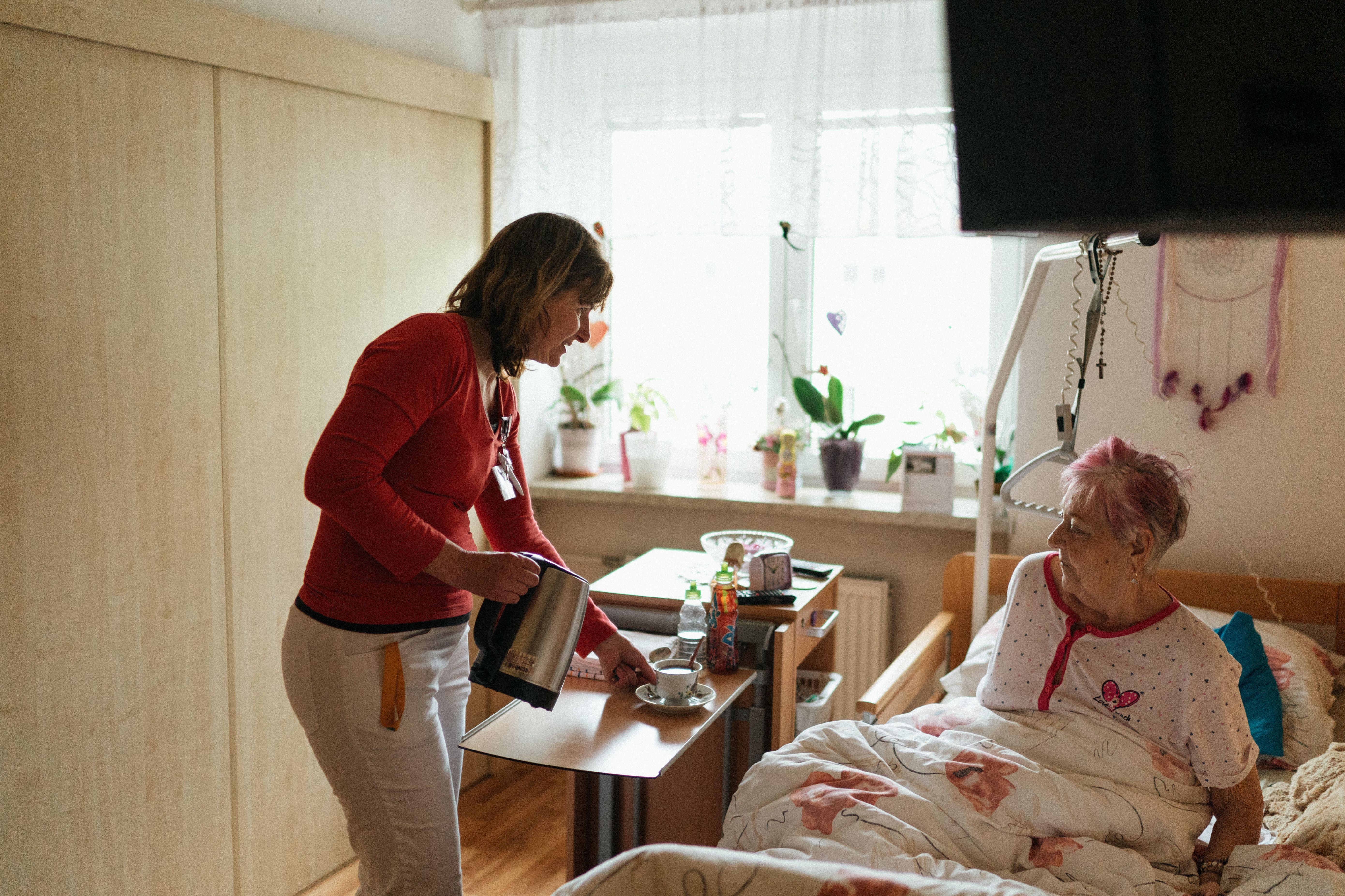 Carer attending to elderly resident